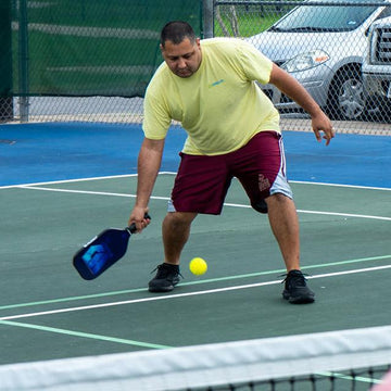  A pickleball player holding HUDEF paddles.