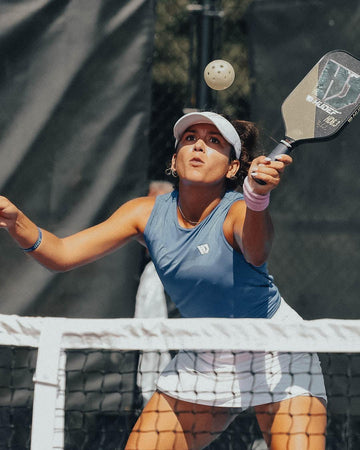 male player holding three HUDEF pickleball paddles
