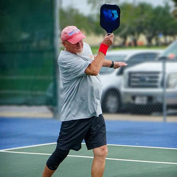 a old men strike the pickleball