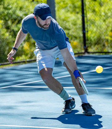 man playing pickleball hitting a ball - Pickelball rules